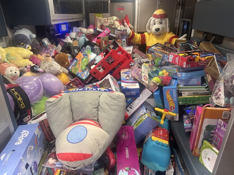 Rehoboth Beach Volunteer Fire Company mascot Sparky stands inside an ambulance stuffed with hundreds of toys donated by community members in 2025. SUBMITTED PHOTOS